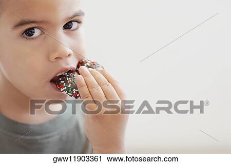 Portrait of a boy eating candy View Large Photo Image Stock Image - Portrait of a boy eating candy. Fotosearch
