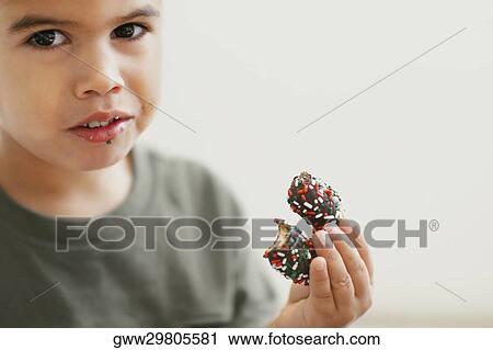 Portrait of a boy eating candy View Large Photo Image Stock Image - Portrait of a boy eating candy. Fotosearch