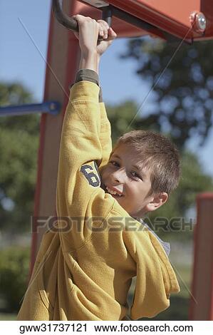 Portrait of a boy hanging on a jungle gym View Large Photo Image Stock Image - Portrait of a boy hanging on a jungle gym. Fotosearch
