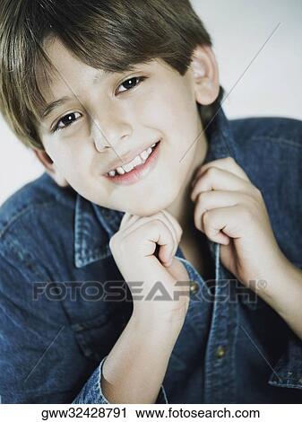 Portrait of a boy holding his shirt collar View Large Photo Image Stock Image - Portrait of a boy holding his shirt collar. Fotosearch