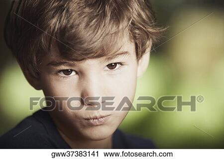 Stock Image - Portrait of a boy puckering his lips. Fotosearch