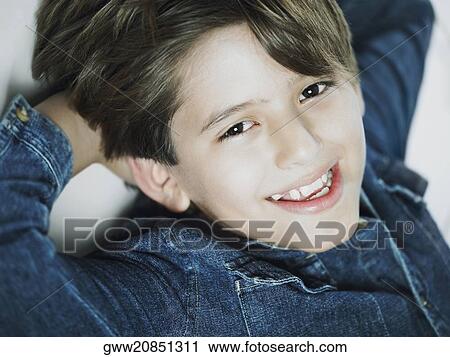 Portrait of a boy smiling with his hands in his hair View Large Photo Image Stock Image - Portrait of a boy smiling with his hands in his hair. Fotosearch