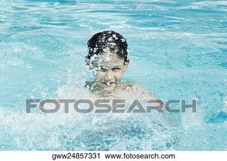 Portrait of a boy splashing water in a swimming pool View Large Photo Image Stock Image - Portrait of a boy splashing water in a swimming pool. Fotosearch
