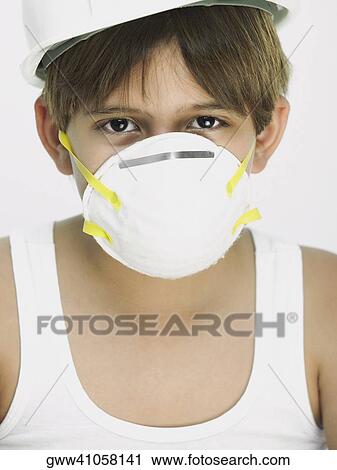 Stock Image - Portrait of a boy wearing a safety mask. Fotosearch