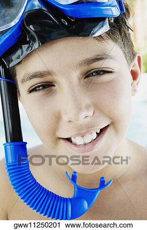 Stock Image - Portrait of a boy wearing a snorkel and scuba mask. Fotosearch