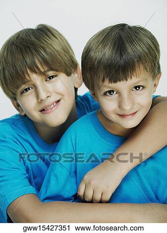 Portrait of a boy with his arm over his brother View Large Photo Image Stock Image - Portrait of a boy with his arm over his brother. Fotosearch