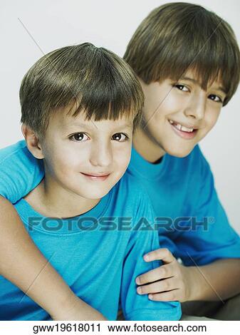 Portrait of a boy with his arm over his brother View Large Photo Image Stock Image - Portrait of a boy with his arm over his brother. Fotosearch