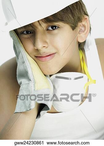 Stock Image - Portrait of a boy with his hand on his cheek. Fotosearch