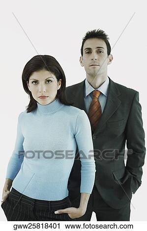 Portrait of a businessman and a businesswoman standing with their hands in their pockets View Large Photo Image Stock Image - Portrait of a businessman and a businesswoman standing with their hands in their pockets. Fotosearch
