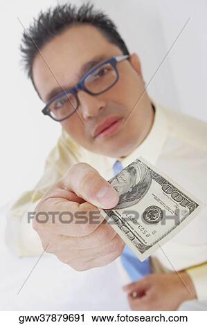 Portrait of a businessman holding an American one hundred dollar bill View Large Photo Image Stock Image - Portrait of a businessman holding an American one hundred dollar bill. Fotosearch