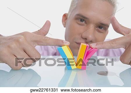 Stock Image - Portrait of a businessman playing with a notepad. Fotosearch