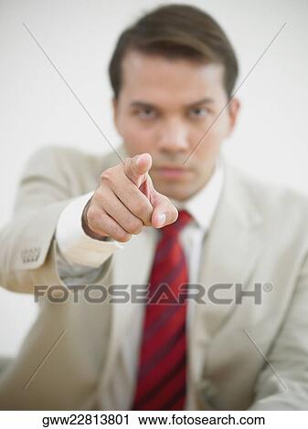 Portrait of a businessman pointing forward View Large Photo Image Stock Image - Portrait of a businessman pointing forward. Fotosearch