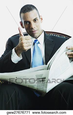 Portrait of a businessman reading a newspaper View Large Photo Image Stock Image - Portrait of a businessman reading a newspaper. Fotosearch