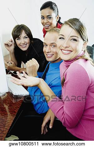 Portrait of a businessman smiling with three businesswomen View Large Photo Image Stock Image - Portrait of a businessman smiling with three businesswomen. Fotosearch