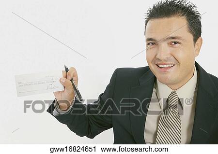 Portrait of a businessman smiling with a pen and a check View Large Photo Image Stock Image - Portrait of a businessman smiling with a pen and a check. Fotosearch