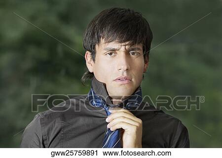 Portrait of a businessman wearing a tie View Large Photo Image Stock Image - Portrait of a businessman wearing a tie. Fotosearch