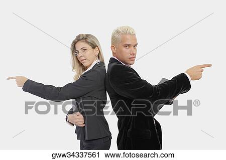 Portrait of a businesswoman and a businessman standing back to back and pointing View Large Photo Image Stock Image - Portrait of a businesswoman and a businessman standing back to back and pointing. Fotosearch