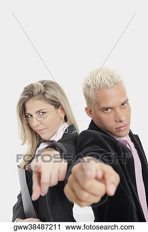 Portrait of a businesswoman and a businessman standing back to back and pointing View Large Photo Image Stock Image - Portrait of a businesswoman and a businessman standing back to back and pointing. Fotosearch