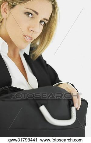 Portrait of a businesswoman holding a bag View Large Photo Image Stock Image - Portrait of a businesswoman holding a bag. Fotosearch