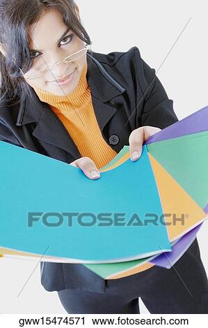 Portrait of a businesswoman holding files View Large Photo Image Stock Image - Portrait of a businesswoman holding files. Fotosearch