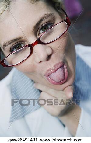 Portrait of a businesswoman sticking her tongue out View Large Photo Image Stock Image - Portrait of a businesswoman sticking her tongue out. Fotosearch