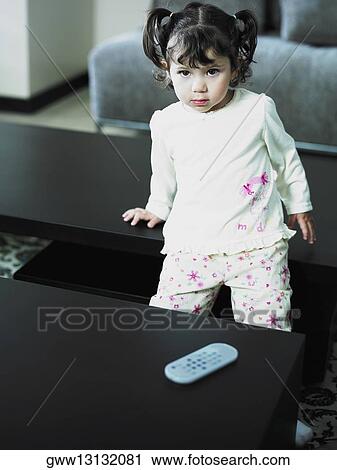 Portrait of a girl leaning against a table View Large Photo Image Stock Image - Portrait of a girl leaning against a table. Fotosearch