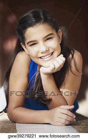 Portrait of a girl smiling with her hand on her chin View Large Photo Image Stock Image - Portrait of a girl smiling with her hand on her chin. Fotosearch