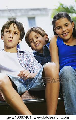 Portrait of a girl smiling with two boys View Large Photo Image Stock Image - Portrait of a girl smiling with two boys. Fotosearch