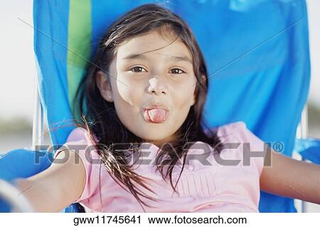 Portrait of a girl sticking her tongue out View Large Photo Image Stock Image - Portrait of a girl sticking her tongue out. Fotosearch