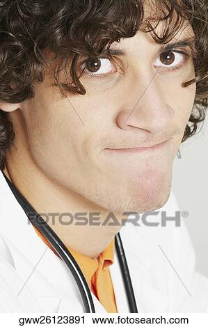 Portrait of a male doctor biting his lips View Large Photo Image Stock Image - Portrait of a male doctor biting his lips. Fotosearch