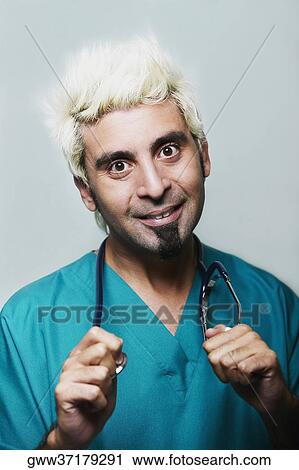 Portrait of a male doctor holding a stethoscope around his neck View Large Photo Image Stock Image - Portrait of a male doctor holding a stethoscope around his neck. Fotosearch