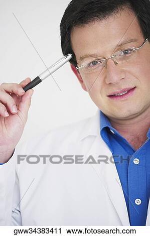 Portrait of a male doctor thinking View Large Photo Image Stock Image - Portrait of a male doctor thinking. Fotosearch