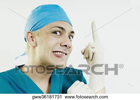 Portrait of a male doctor wearing surgical gloves View Large Photo Image Stock Image - Portrait of a male doctor wearing surgical gloves. Fotosearch