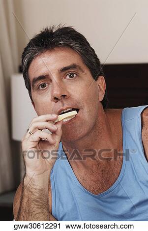 Portrait of a mature man holding bubble gum near his mouth View Large Photo Image Stock Image - Portrait of a mature man holding bubble gum near his mouth. Fotosearch