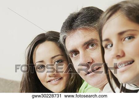 Portrait of a mature man with his two daughters View Large Photo Image Stock Image - Portrait of a mature man with his two daughters. Fotosearch
