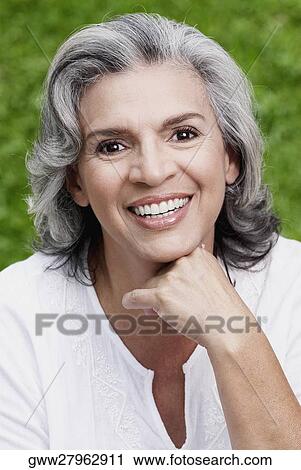 Portrait of a mature woman smiling View Large Photo Image Stock Image - Portrait of a mature woman smiling. Fotosearch