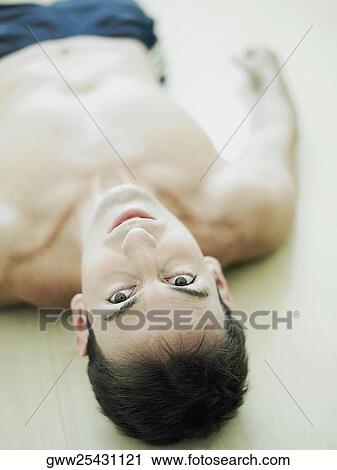 Portrait of a mid adult man lying on the floor View Large Photo Image Stock Image - Portrait of a mid adult man lying on the floor. Fotosearch
