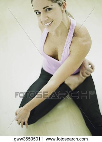 Portrait of a mid adult woman in a yoga pose View Large Photo Image Stock Image - Portrait of a mid adult woman in a yoga pose. Fotosearch