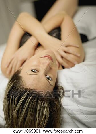 Portrait of a mid adult woman lying on her back View Large Photo Image Stock Image - Portrait of a mid adult woman lying on her back. Fotosearch