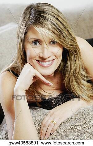 Portrait of a mid adult woman with her hand on her chin View Large Photo Image Stock Image - Portrait of a mid adult woman with her hand on her chin. Fotosearch