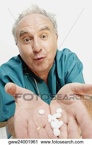 Portrait of a senior male doctor showing tablets View Large Photo Image Stock Image - Portrait of a senior male doctor showing tablets. Fotosearch