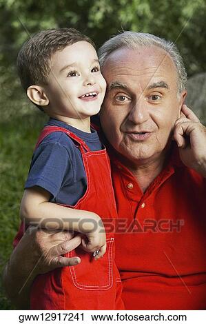 Portrait of a senior man and his grandson smiling View Large Photo Image Stock Image - Portrait of a senior man and his grandson smiling. Fotosearch