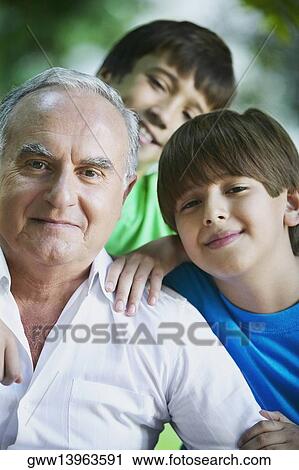 Portrait of a senior man and his two grandsons smiling View Large Photo Image Stock Image - Portrait of a senior man and his two grandsons smiling. Fotosearch