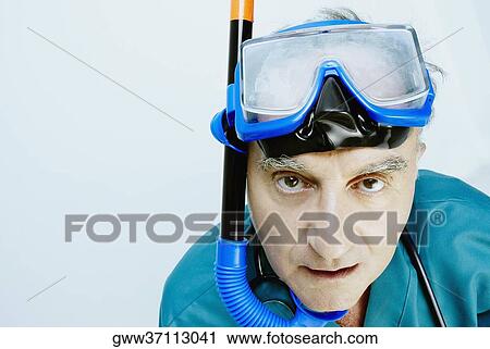 Stock Image - Portrait of a senior man wearing scuba mask. Fotosearch