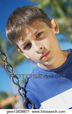 Portrait of a teenage boy on a swing View Large Photo Image Stock Image - Portrait of a teenage boy on a swing. Fotosearch