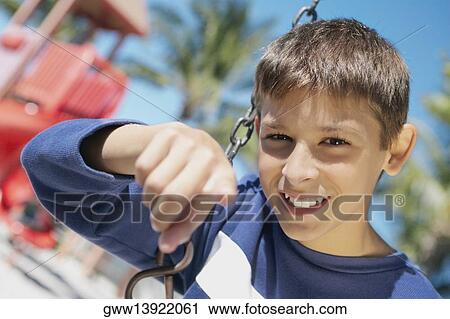 Portrait of a teenage boy smiling and pointing View Large Photo Image Stock Image - Portrait of a teenage boy smiling and pointing. Fotosearch