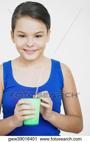 Portrait of a teenage girl holding a glass and smiling View Large Photo Image Stock Image - Portrait of a teenage girl holding a glass and smiling. Fotosearch