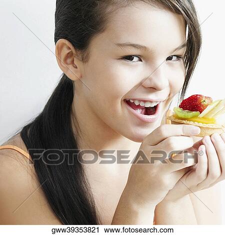 Portrait of a teenage girl holding a fruit tart and smiling View Large Photo Image Stock Image - Portrait of a teenage girl holding a fruit tart and smiling. Fotosearch
