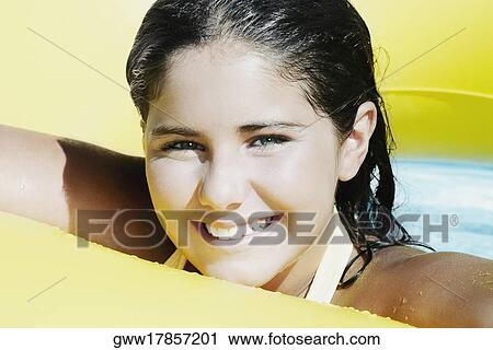 Portrait of a teenage girl with an inflatable ring in a swimming pool View Large Photo Image Stock Image - Portrait of a teenage girl with an inflatable ring in a swimming pool. Fotosearch