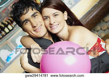 Portrait of a young couple embracing each other View Large Photo Image Stock Image - Portrait of a young couple embracing each other. Fotosearch